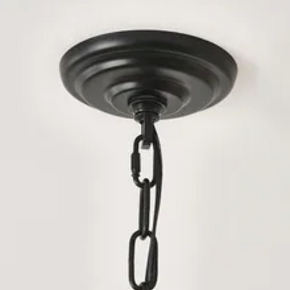 Oversized black farmhouse chandelier with 33 candle-style lights on a wagon wheel frame, ideal for high ceilings, dining rooms, and entryways