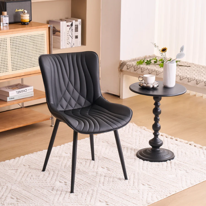 Set of 2 black faux leather dining chairs with fishtail backrest design and black metal legs, ideal for modern and contemporary dining spaces.


