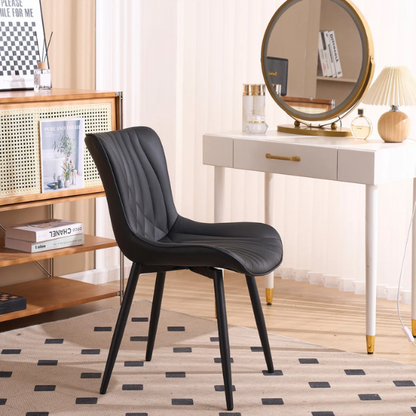 Set of 2 black faux leather dining chairs with fishtail backrest design and black metal legs, ideal for modern and contemporary dining spaces.

