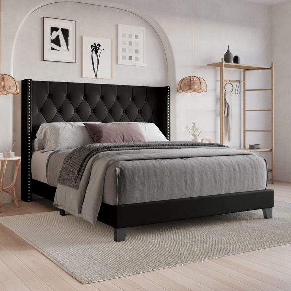 Black queen-size bed with faux leather upholstery, tufted wingback headboard, nailhead trim, and low-profile wood frame.

