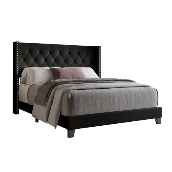 Black queen-size bed with faux leather upholstery, tufted wingback headboard, nailhead trim, and low-profile wood frame.

