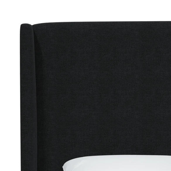 Black king-size upholstered bed in linen fabric with wingback headboard and low-profile black metal legs.

