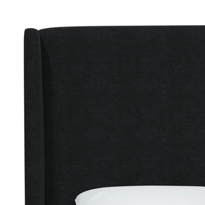 Black king-size upholstered bed in linen fabric with wingback headboard and low-profile black metal legs.

