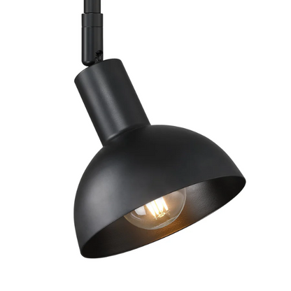 Black plug-in wall sconce with adjustable metal arm and bell-shaped shade, featuring inline on/off switch and matching black cord cover, ideal for task lighting or bedside use.


