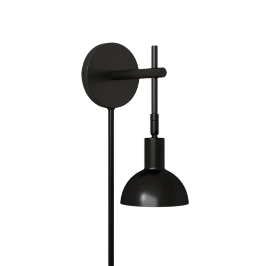 Black plug-in wall sconce with adjustable metal arm and bell-shaped shade, featuring inline on/off switch and matching black cord cover, ideal for task lighting or bedside use.

