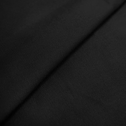 Black king-size upholstered bed in twill fabric with wingback headboard and low-profile black metal legs.

