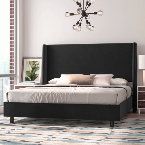 Black king-size upholstered bed in twill fabric with wingback headboard and low-profile black metal legs.


