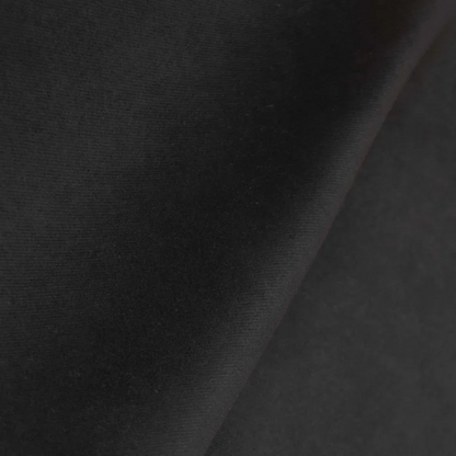Black king-size upholstered bed with velvet fabric, wingback headboard, and low-profile black metal legs.

