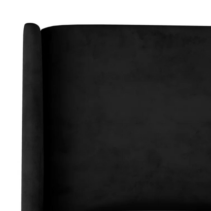 Black king-size upholstered bed with velvet fabric, wingback headboard, and low-profile black metal legs.

