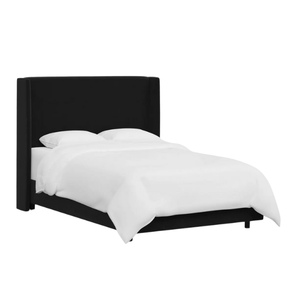 Black king-size upholstered bed with velvet fabric, wingback headboard, and low-profile black metal legs.

