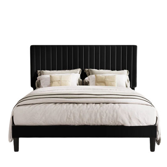Black velvet upholstered queen bed with tufted wingback headboard and low-profile frame.

