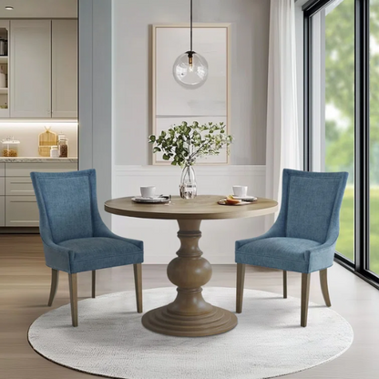 Set of 2 upholstered armless dining chairs in rich blue chenille with solid wood legs, high backs, and piped detailing.

