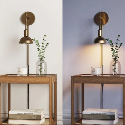 Brass plug-in wall sconce with adjustable swing arm and bell shade, featuring a built-in switch and cord cover for modern bedroom or reading nook lighting

