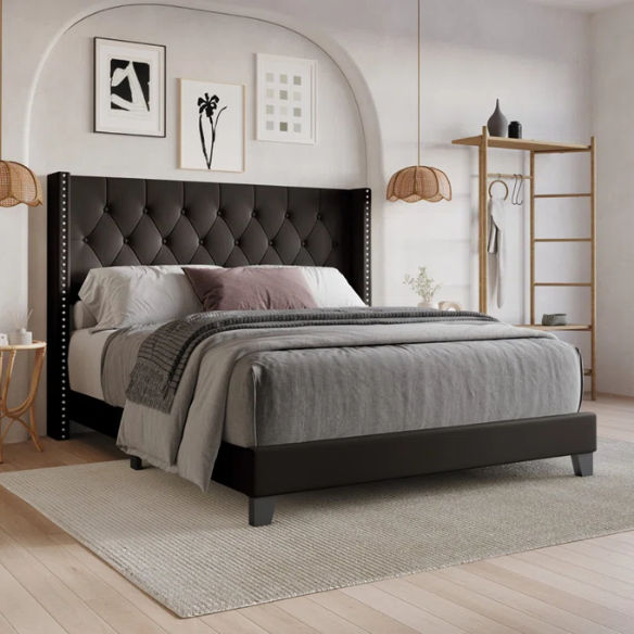Queen-size bed in brown faux leather with tufted wingback headboard, nailhead trim, and low-profile wooden frame.

