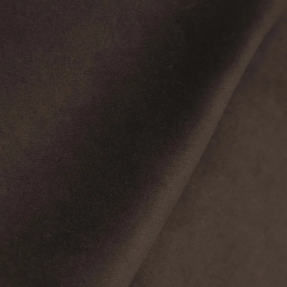 Brown king-size upholstered bed in velvet fabric with wingback headboard and low-profile black metal legs.

