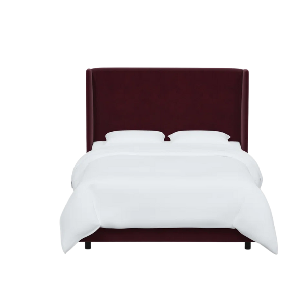Burgundy king-size upholstered bed in velvet fabric with wingback headboard and low-profile black metal legs.

