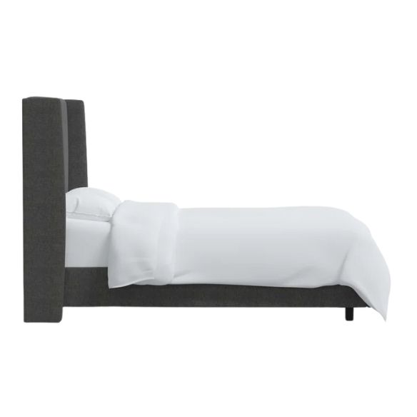 Charcoal grey king-size upholstered bed in linen fabric with wingback headboard and low-profile black metal legs.

