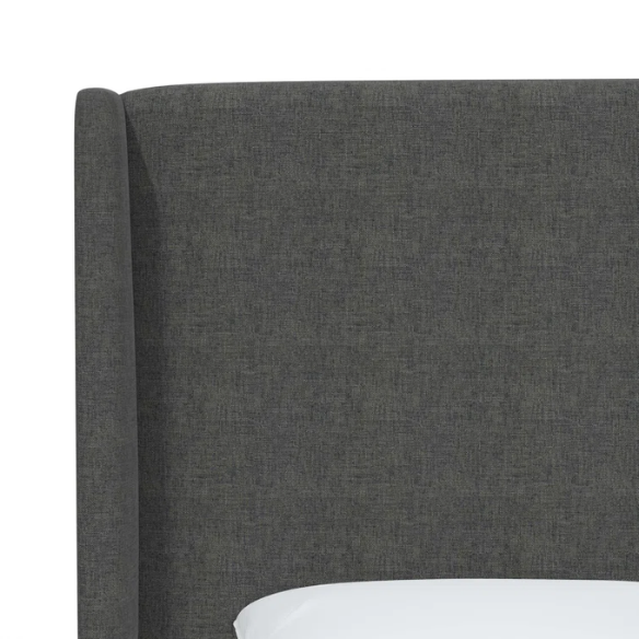 Charcoal grey king-size upholstered bed in linen fabric with wingback headboard and low-profile black metal legs.

