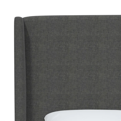 Charcoal grey king-size upholstered bed in linen fabric with wingback headboard and low-profile black metal legs.

