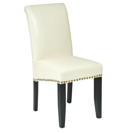 Cream faux leather Parsons chair with scrolled high back, antique bronze nailhead trim, and solid wood legs