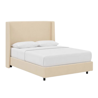 Cream king-size upholstered bed in velvet fabric with wingback headboard and low-profile black metal legs.

