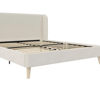 Light cream velvet upholstered queen platform bed with wingback tufted headboard and mid-century angled wood legs.

