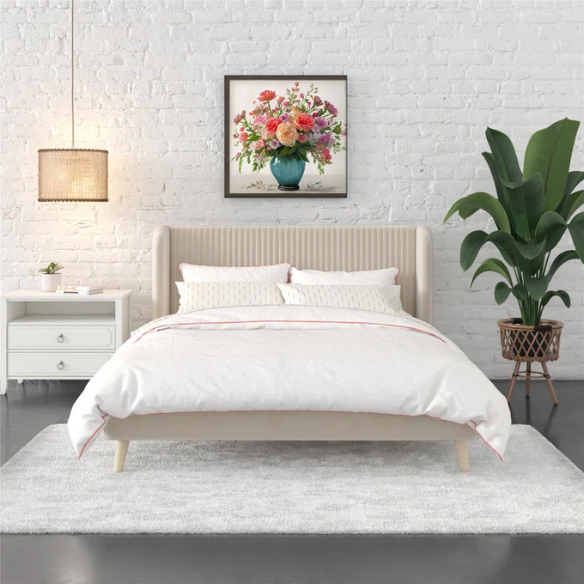 Light cream velvet upholstered queen platform bed with wingback tufted headboard and mid-century angled wood legs.

