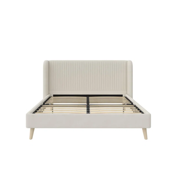 Light cream velvet upholstered queen platform bed with wingback tufted headboard and mid-century angled wood legs.

