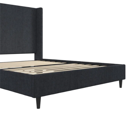 Dark blue canvas queen-size platform bed with tall wingback headboard and black tapered legs.

