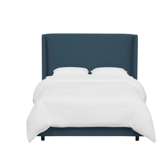 Dark blue king-size upholstered bed in linen fabric with wingback headboard and black metal legs.

