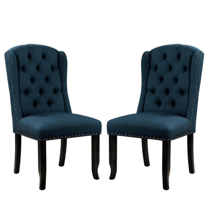 Set of two dark blue upholstered farmhouse dining chairs with tufted backs, brass nailhead trim, and antique black wood legs.

