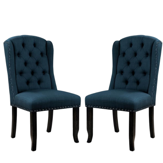 Set of two dark blue upholstered farmhouse dining chairs with tufted backs, brass nailhead trim, and antique black wood legs.

