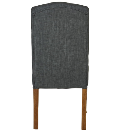 Set of 2 dark grey button-tufted farmhouse dining chairs with rustic wood legs, nailhead trim, and upholstered linen-like fabric.

