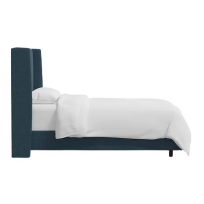 Deep teal king-size upholstered bed in linen fabric with wingback headboard and low-profile black metal legs.

