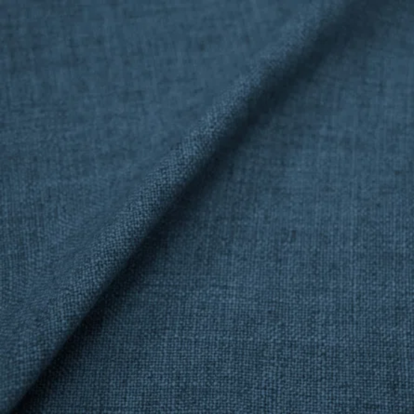 Deep teal king-size upholstered bed in linen fabric with wingback headboard and low-profile black metal legs.

