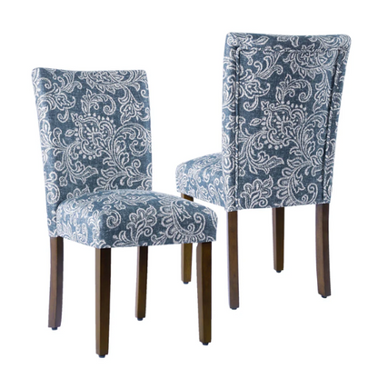 Set of two Parsons dining chairs with denim blue and white floral upholstery, high back design, scalloped seat front, and wood legs