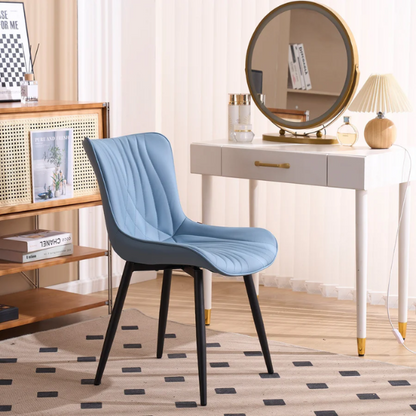 Set of 2 dusty blue faux leather dining chairs with fishtail tufted back and black metal legs, perfect for modern dining rooms or kitchen spaces.

