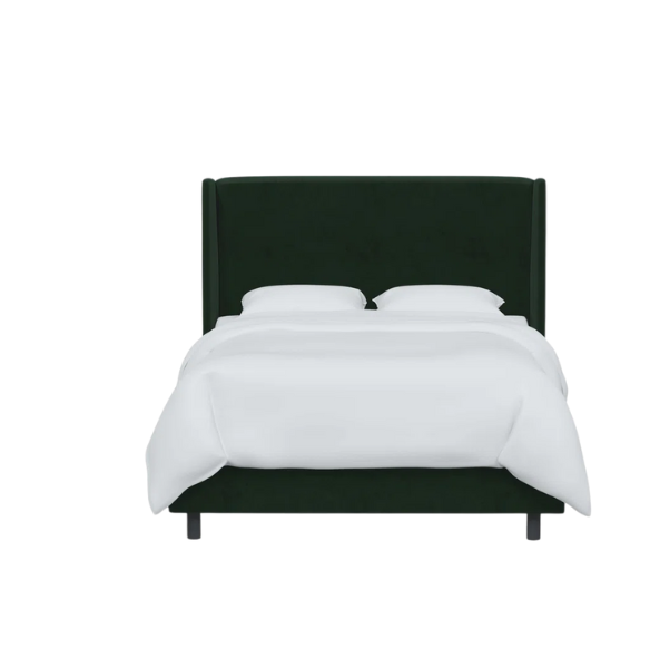 Emerald green king-size upholstered bed in velvet fabric with wingback headboard and low-profile black metal legs.

