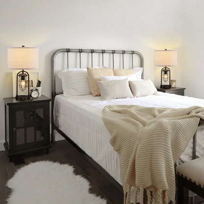 Set of two 21.5-inch espresso table lamps with arch-shaped metal bases, beige fabric drum shades, built-in USB-A and USB-C charging ports, and lantern-style night lights — ideal for modern, industrial, or transitional interiors.

