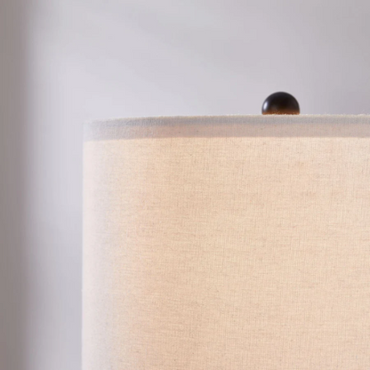 Set of two 21.5-inch espresso table lamps with arch-shaped metal bases, beige fabric drum shades, built-in USB-A and USB-C charging ports, and lantern-style night lights — ideal for modern, industrial, or transitional interiors.

