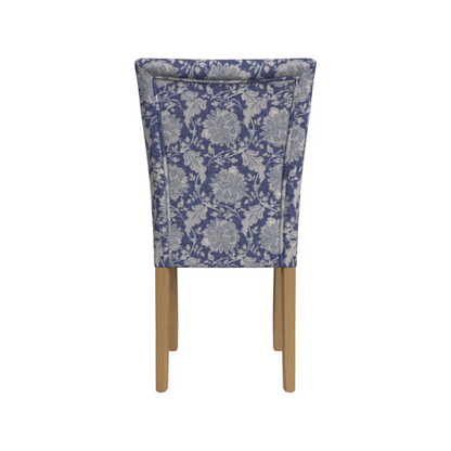 Set of two blue and cream floral Parsons dining chairs with high back, scalloped seat front, and wood legs in a traditional design