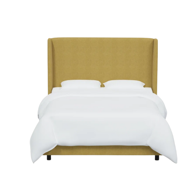 Golden yellow king-size upholstered bed in linen fabric with wingback headboard and black metal legs.

