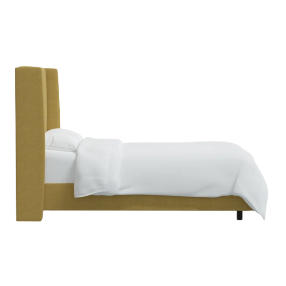 Golden yellow king-size upholstered bed in linen fabric with wingback headboard and black metal legs.

