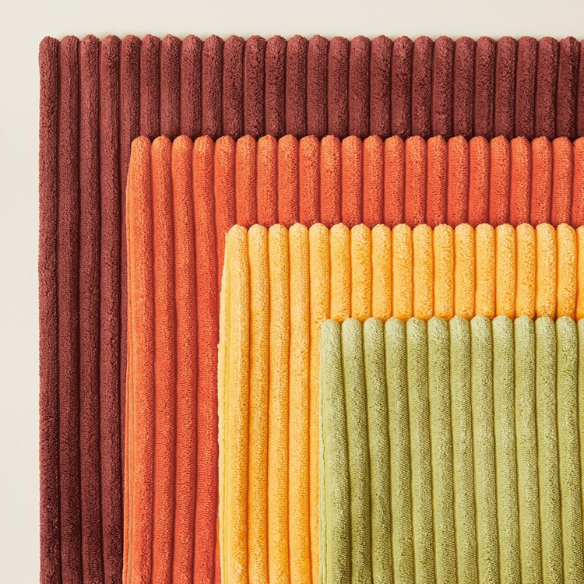 Set of 4 striped corduroy pillow covers in green, red, orange, and yellow – 18x18 decorative cushion covers with gradient pattern and hidden zippers for boho or festive home decor.