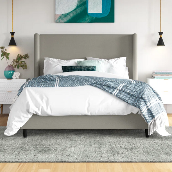 Grey canvas queen platform bed with extra-tall wingback tufted headboard and black tapered legs.

