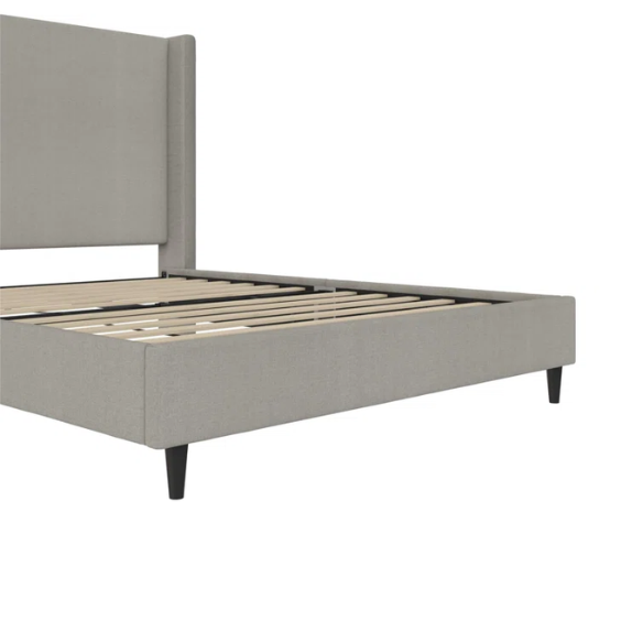 Grey canvas queen platform bed with extra-tall wingback tufted headboard and black tapered legs.

