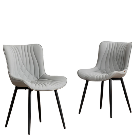 Set of 2 grey faux leather dining chairs with fishtail tufted backs and black metal legs, ideal for modern and minimalist dining room interiors.

