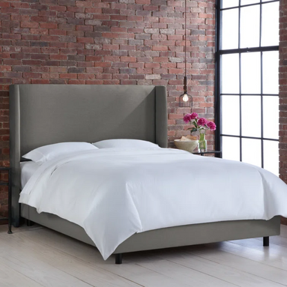 Grey king-size upholstered bed in linen fabric with wingback headboard and black metal legs.

