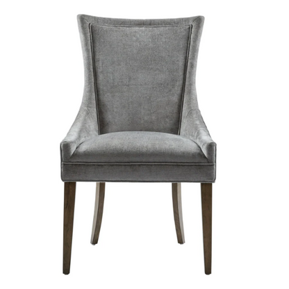Set of 2 upholstered armless dining chairs in soft grey chenille with high backs, piped detailing, and solid wood legs.

