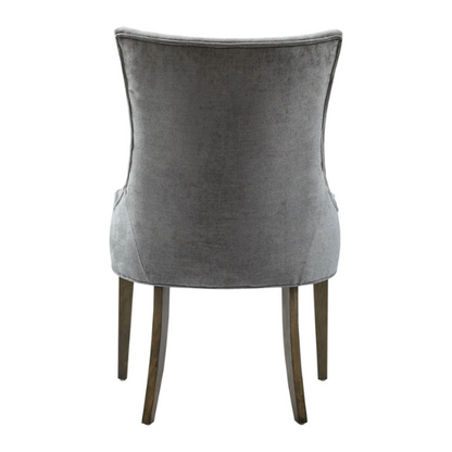 Set of 2 upholstered armless dining chairs in soft grey chenille with high backs, piped detailing, and solid wood legs.

